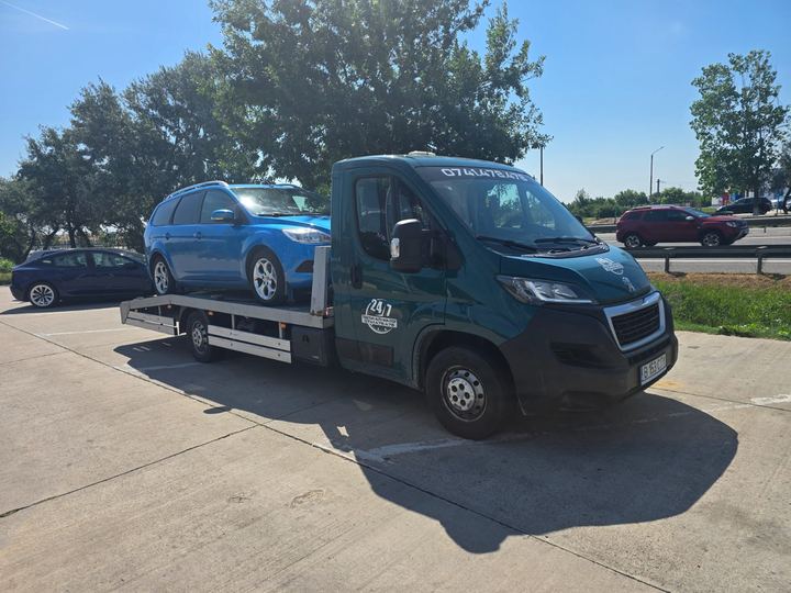 Transport auto pe platformă: autoturism break albastru încărcat
